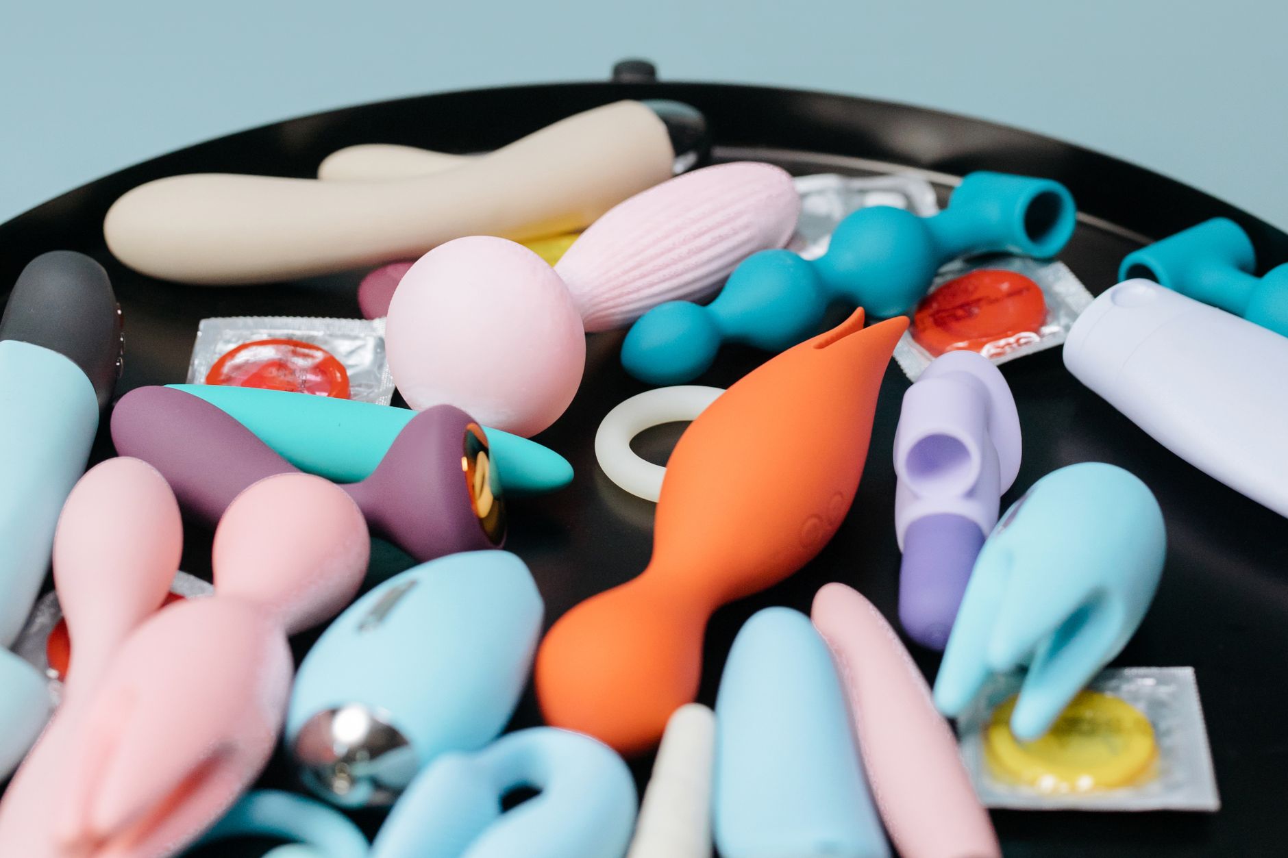 A vibrant yellow silicone vibrator surrounded by fresh elements on a cheerful background, symbolizing renewed sensation