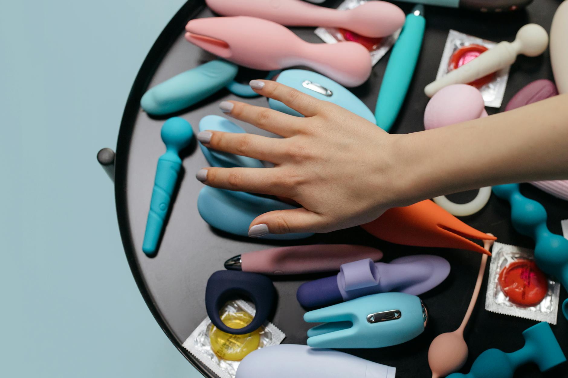 Woman holding clitoral vibrators, exploring options for sensitive pleasure