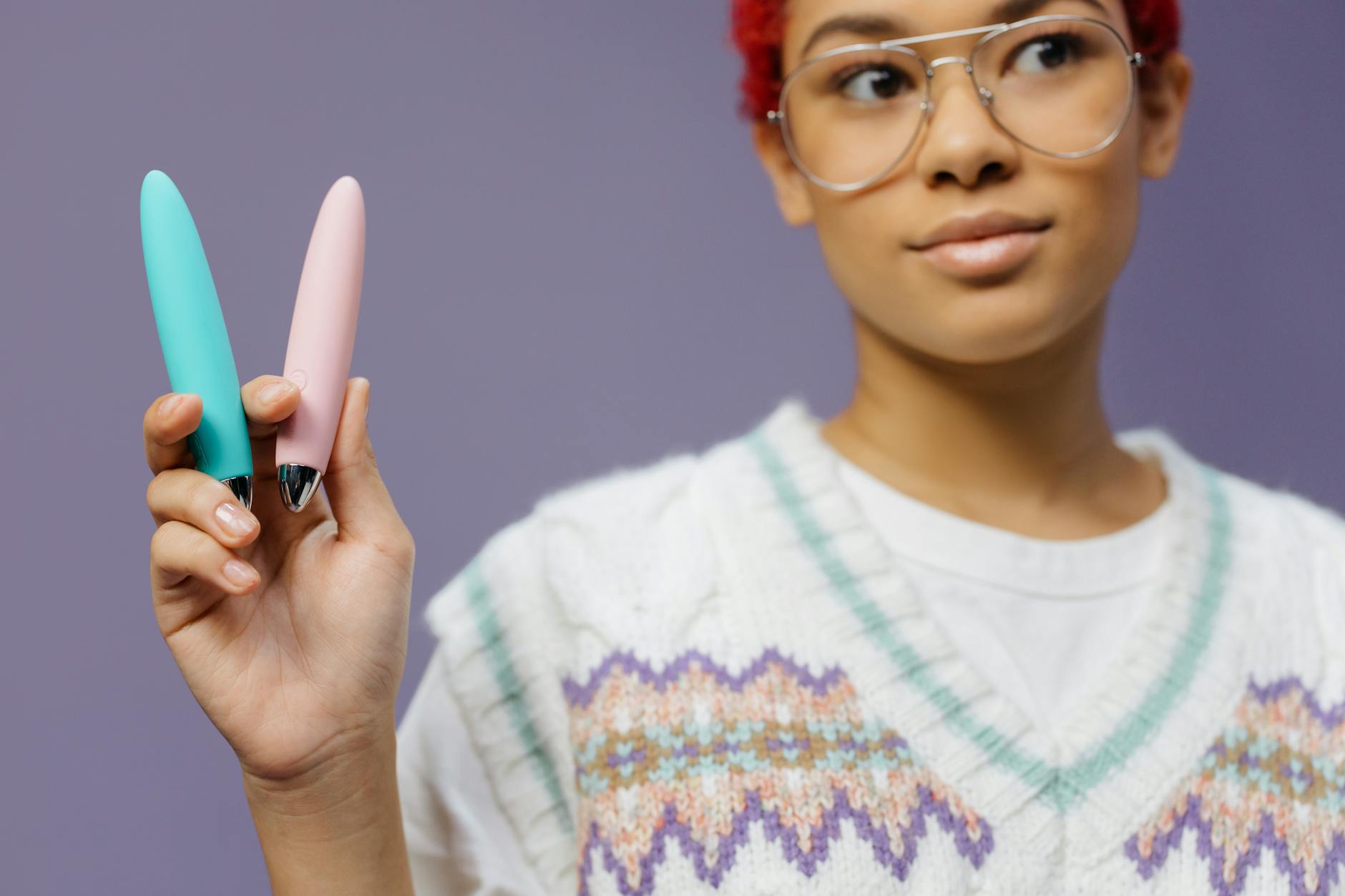 Hands holding a sleek blue vibrator, representing intimacy and personal pleasure