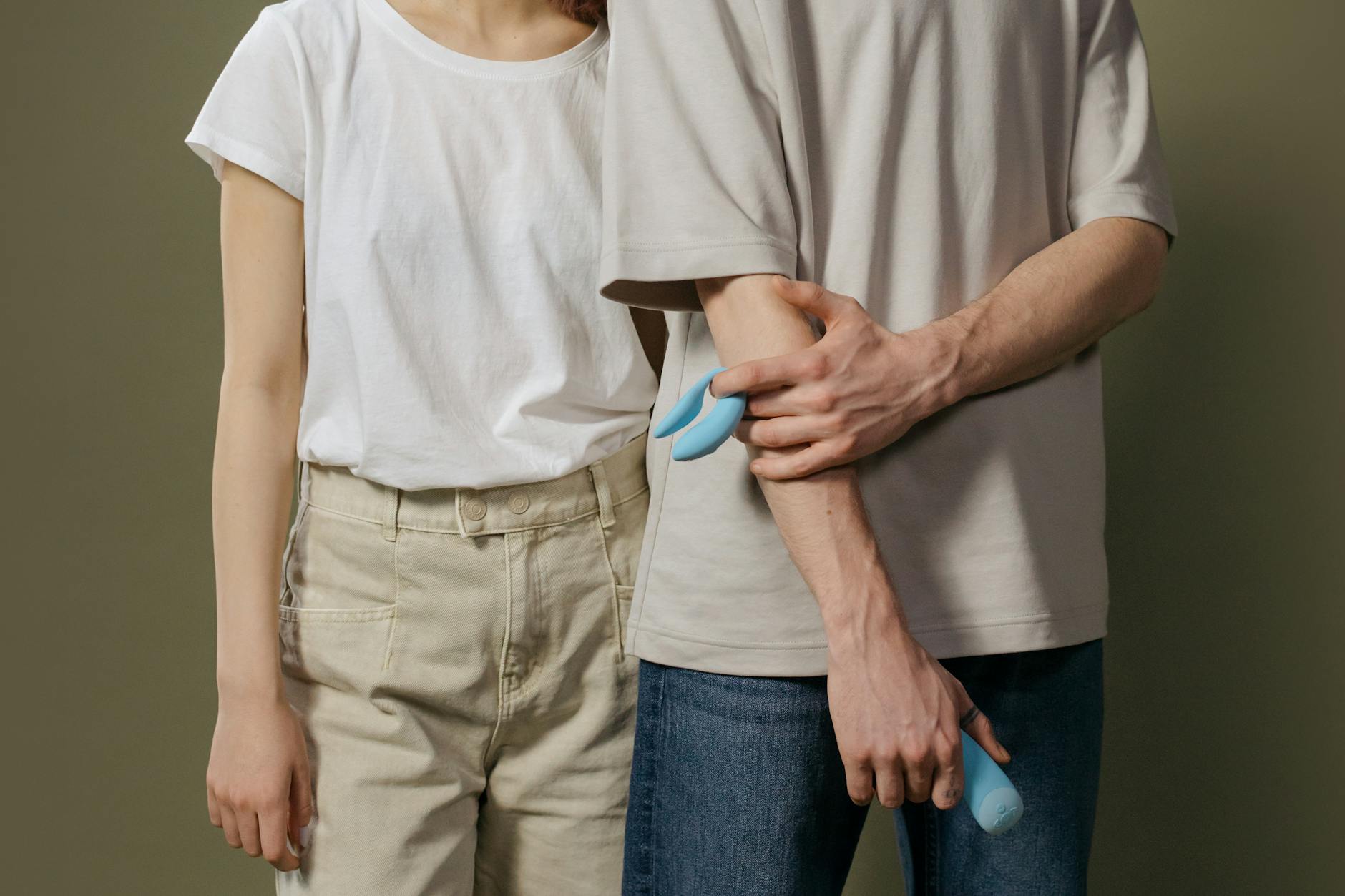 A couple standing together, discussing intimacy and comfort with modern toys